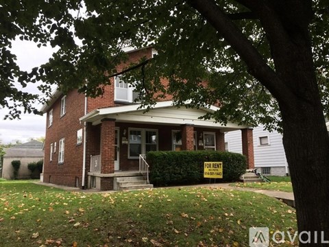 A house with a "For Rent" sign in front.