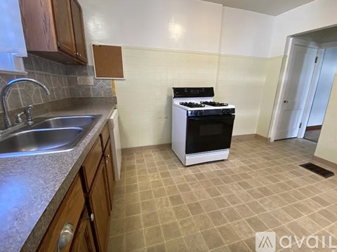 A kitchen with a stove and sink.