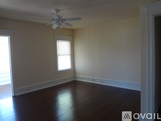 A room with a ceiling fan and a window.