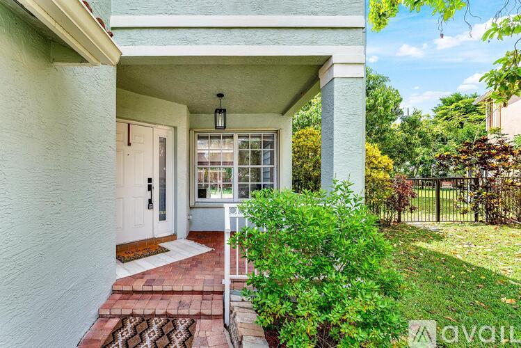 A house entrance with a white door and a glass window.