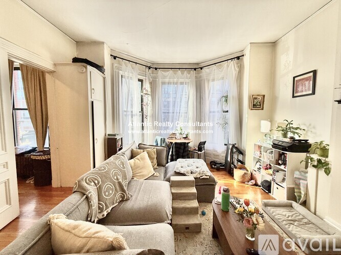 A living room with a grey couch and a coffee table.