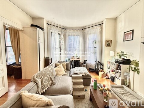 A living room with a grey couch and a coffee table.
