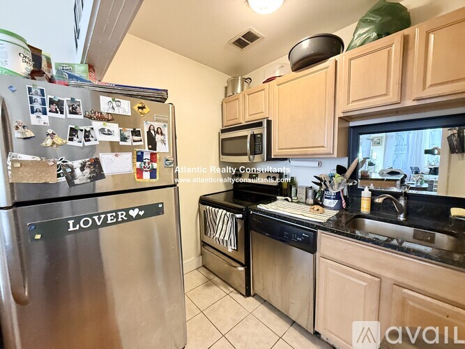 A kitchen with a refrigerator that says "LOVER" on it.