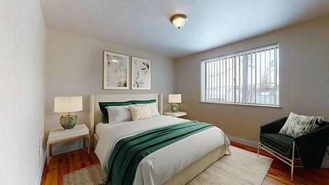 A bedroom with a bed, chair, and two lamps.
