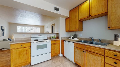 A kitchen with wooden cabinets and white appliances.