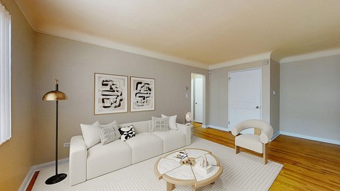 A living room with a white couch and a coffee table.