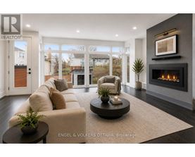 A modern living room with a fireplace and a large window.