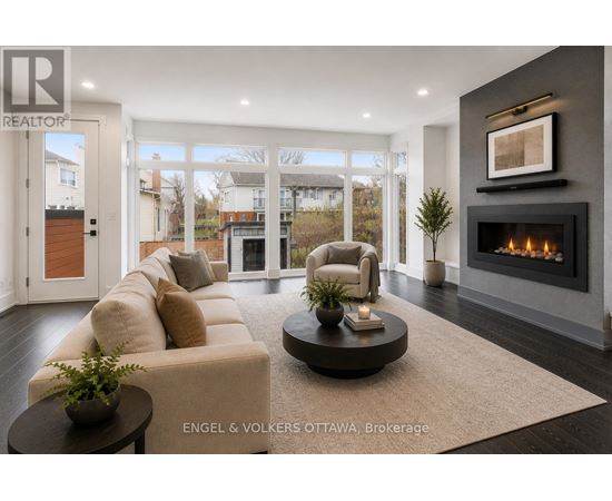 A modern living room with a fireplace and a large window.