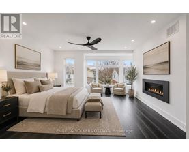 A bedroom with a large bed and a fireplace.