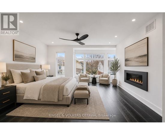 A bedroom with a large bed and a fireplace.