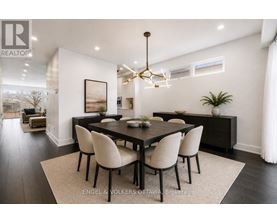 A modern dining room with a large table and chairs.