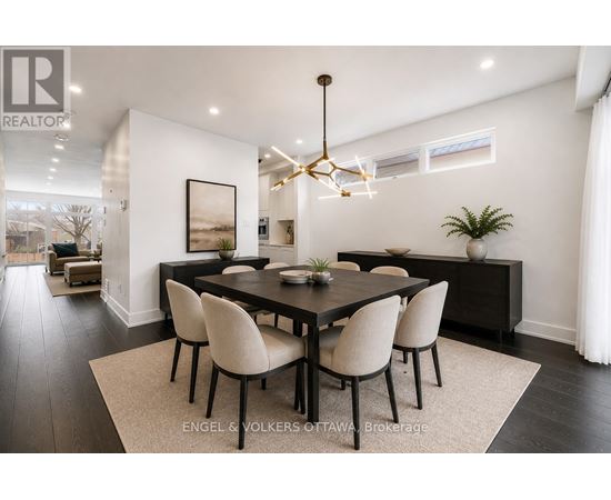 A modern dining room with a large table and chairs.