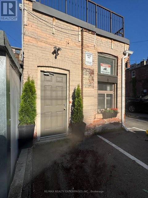 A building with a Real Estate sign on it.