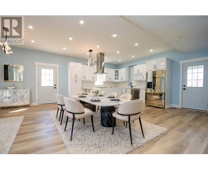A dining room with a table set for four.