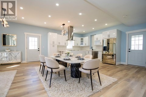 A dining room with a table set for four.