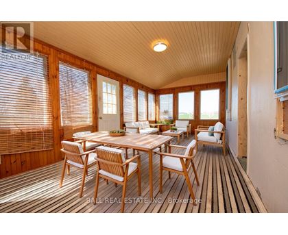 A sunny room with a table and chairs.