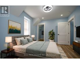A bedroom with a bed, nightstands, and a painting on the wall.
