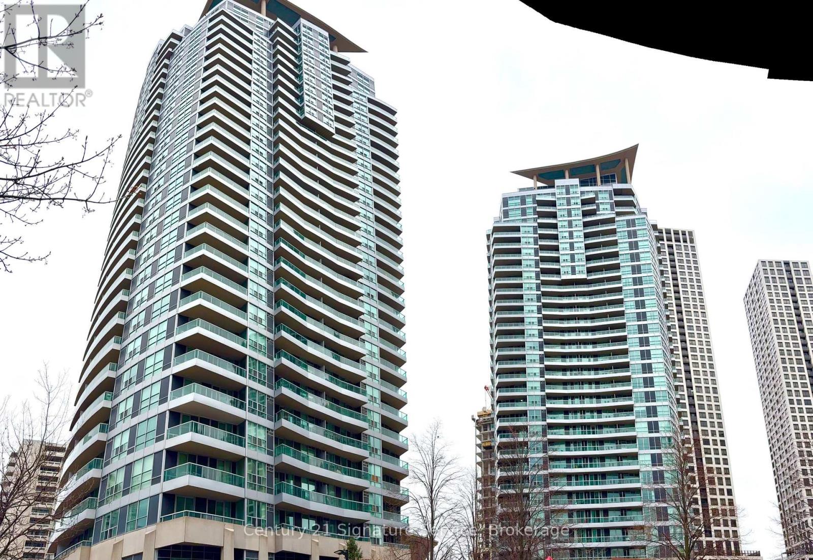 Two tall buildings with balconies are shown in the image.
