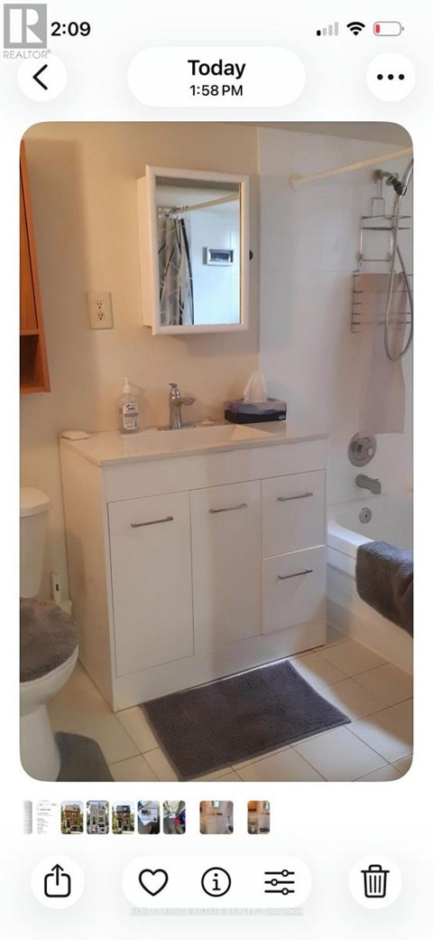 A bathroom with a white sink and a mirror above it.