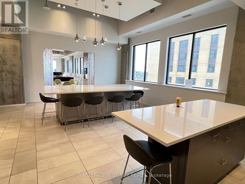 A spacious kitchen with a large island and modern furniture.