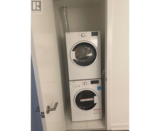 A white washing machine and dryer in a small cabinet.