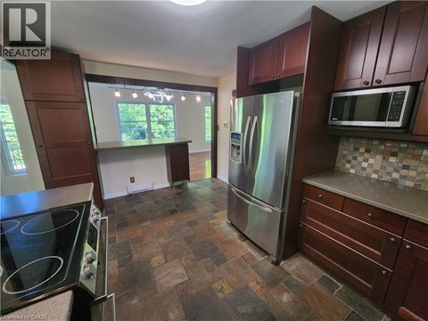 A kitchen with a stove top oven and a refrigerator.