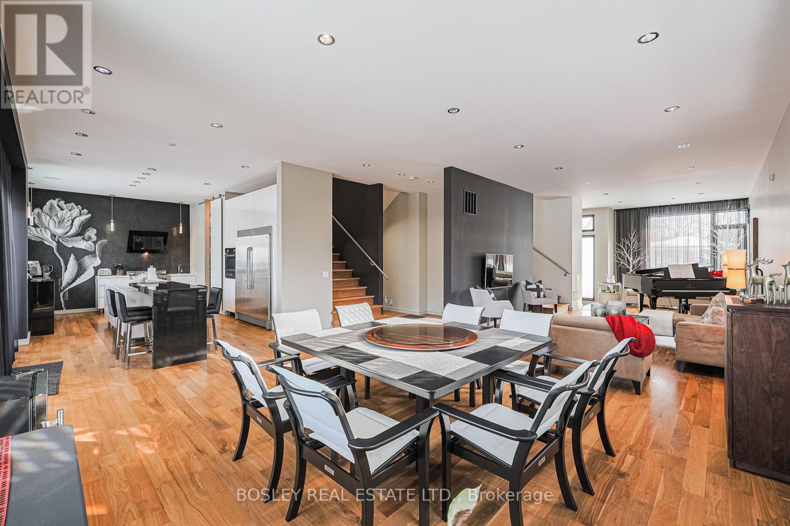 A modern dining room with a large table and chairs.