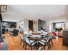 A modern dining room with a large table and chairs.