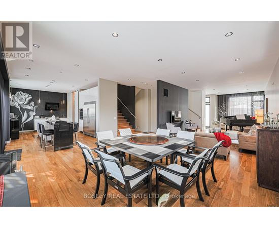 A modern dining room with a large table and chairs.