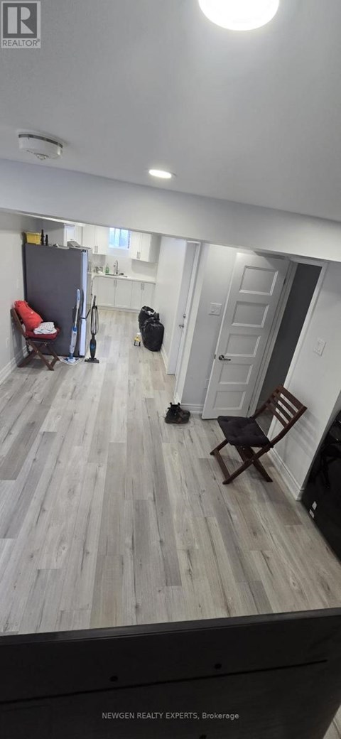 A room with wooden flooring and a chair.