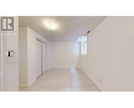 A white room with a door and a window.