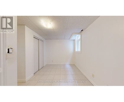 A white room with a door and a window.