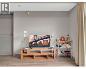 A living room with a TV and a wooden stand.