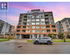 A modern apartment building with a car parked in front.
