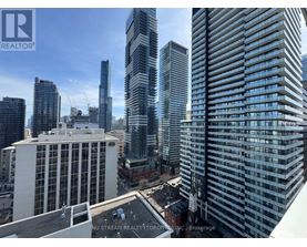 A cityscape with tall buildings and a clear sky.
