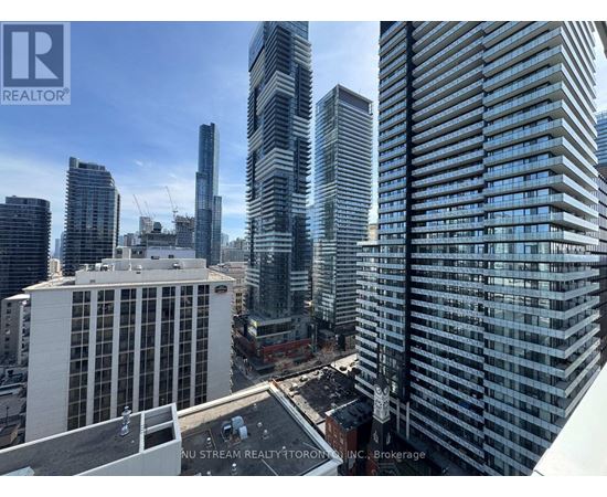A cityscape with tall buildings and a clear sky.