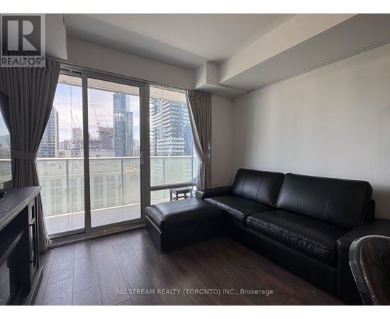 A bedroom with a large bed and a view of the city.