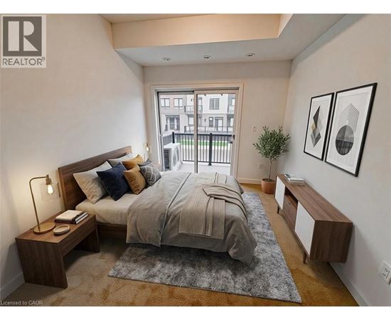 A bedroom with a large bed, a nightstand with a lamp, and a window overlooking a balcony.