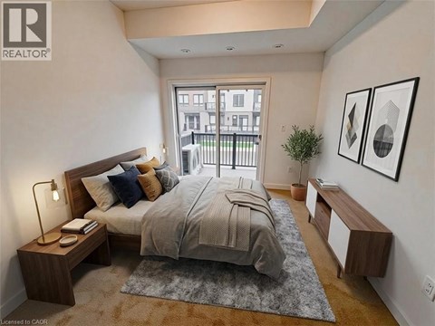 A bedroom with a large bed, a nightstand with a lamp, and a window overlooking a balcony.