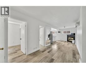 A spacious living room with a fireplace and hardwood floors.