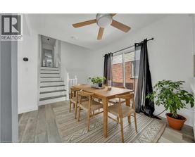 A dining room with a wooden table and chairs.
