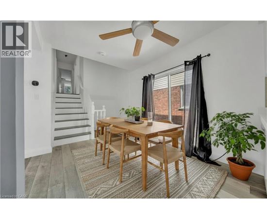 A dining room with a wooden table and chairs.