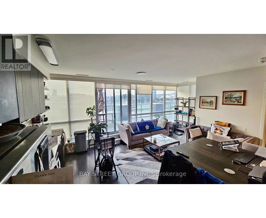 A living room with a couch, coffee table, and a large window.