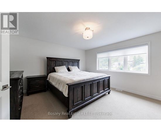 A bedroom with a large bed and a window.