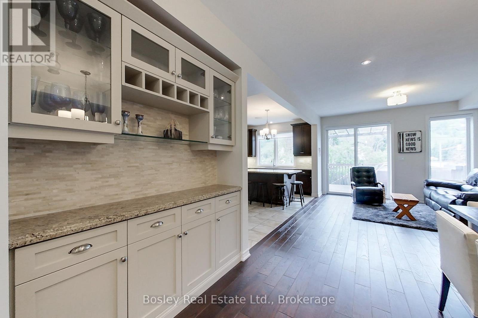 A kitchen with white cabinets and a counter top.