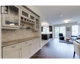 A kitchen with white cabinets and a counter top.