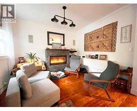A living room with a fireplace and a chair.