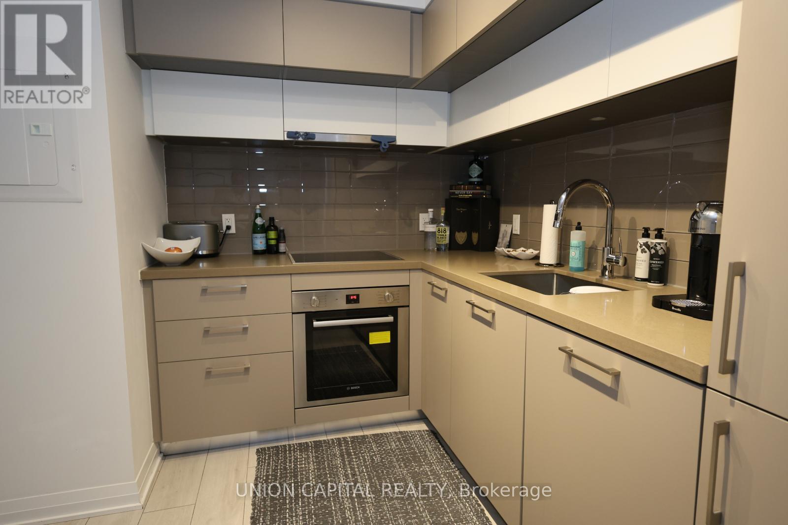 A kitchen with a Union Capital Realty Brokerage logo.