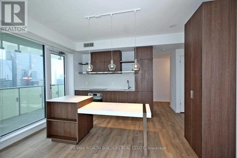 A modern kitchen with wooden cabinets and a white countertop.