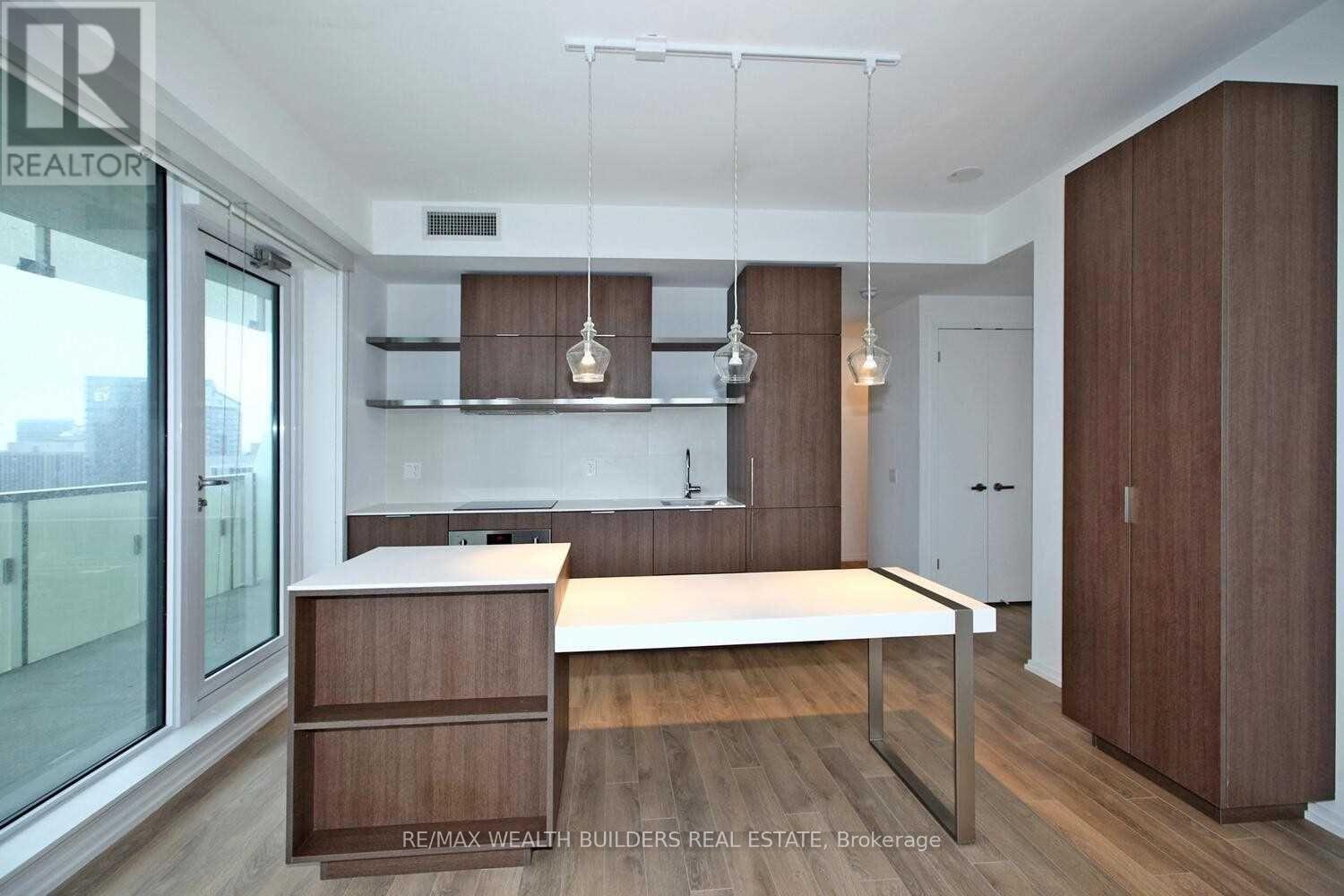 A modern kitchen with wooden cabinets and a white countertop.